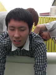 Kaede and Fuji grab the lube and a dildo and bend Jo over the small couch pulling off his shorts
